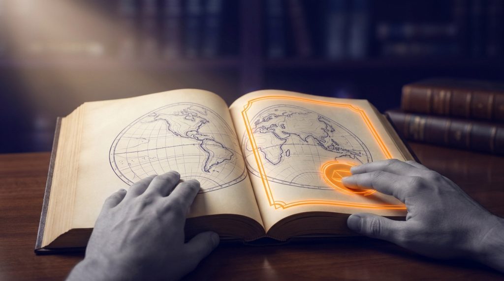 Mains posées sur un livre ancien ouvert illustré d'une carte du monde avec des détails lumineux et technologiques.